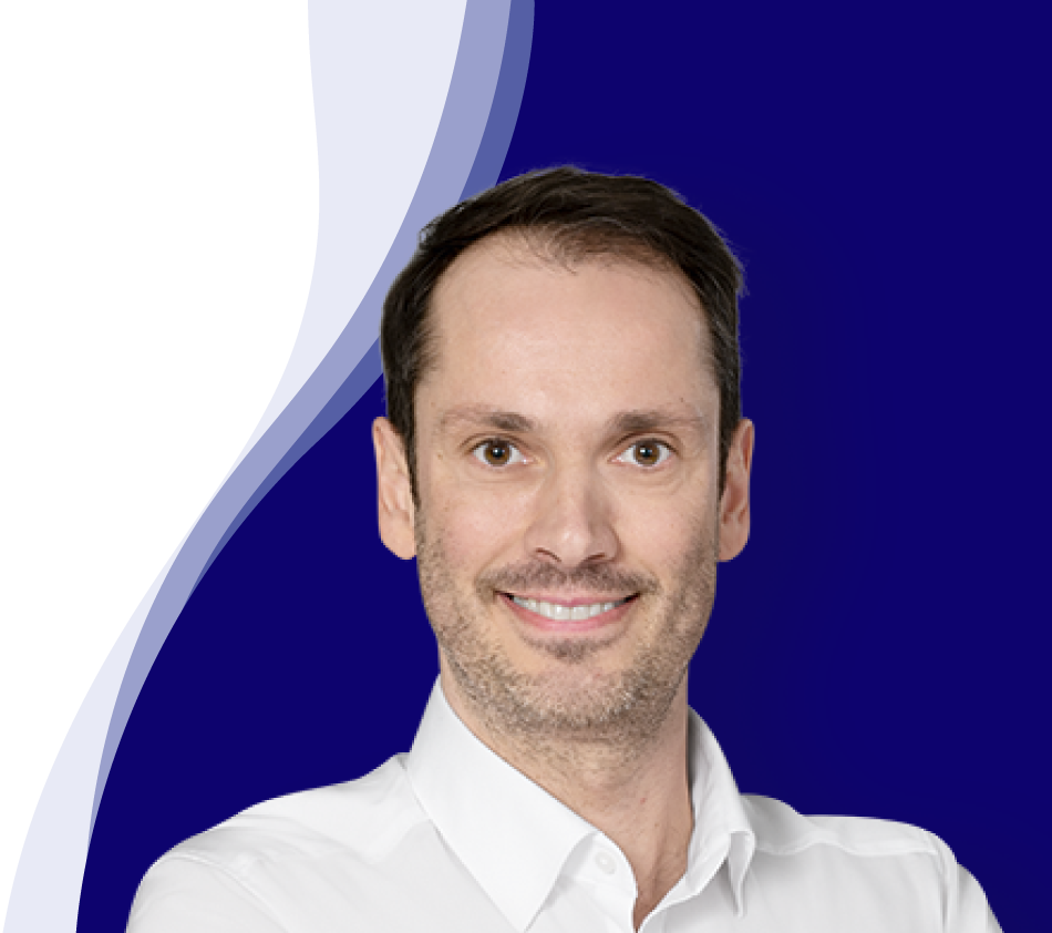 Bernhard Maier smiles at the camera. He is wearing a white shirt with an open collar. He has short, dark brown hair and a slight shadow of a beard. The background has a modern design with curved waves in dark blue, white and light blue.