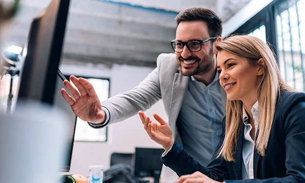 Un informaticien manipule un ordinateur portable dans une salle de serveurs